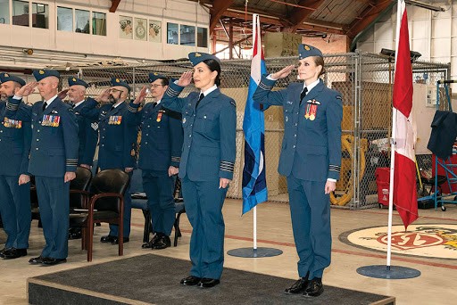 417 Combat Support Squadron (CSS) Commanding Officer, Major Alexia Hannam (right) and Incoming 417 CSS Honorary Colonel, Kendra Kincade salute for the National Anthem during the Honorary Colonel Investiture Ceremony held inside Hangar 6 on March 1, 2019 at 4 Wing, Cold Lake, Alberta. PHOTO: Sailor Second Class Erica Seymour
