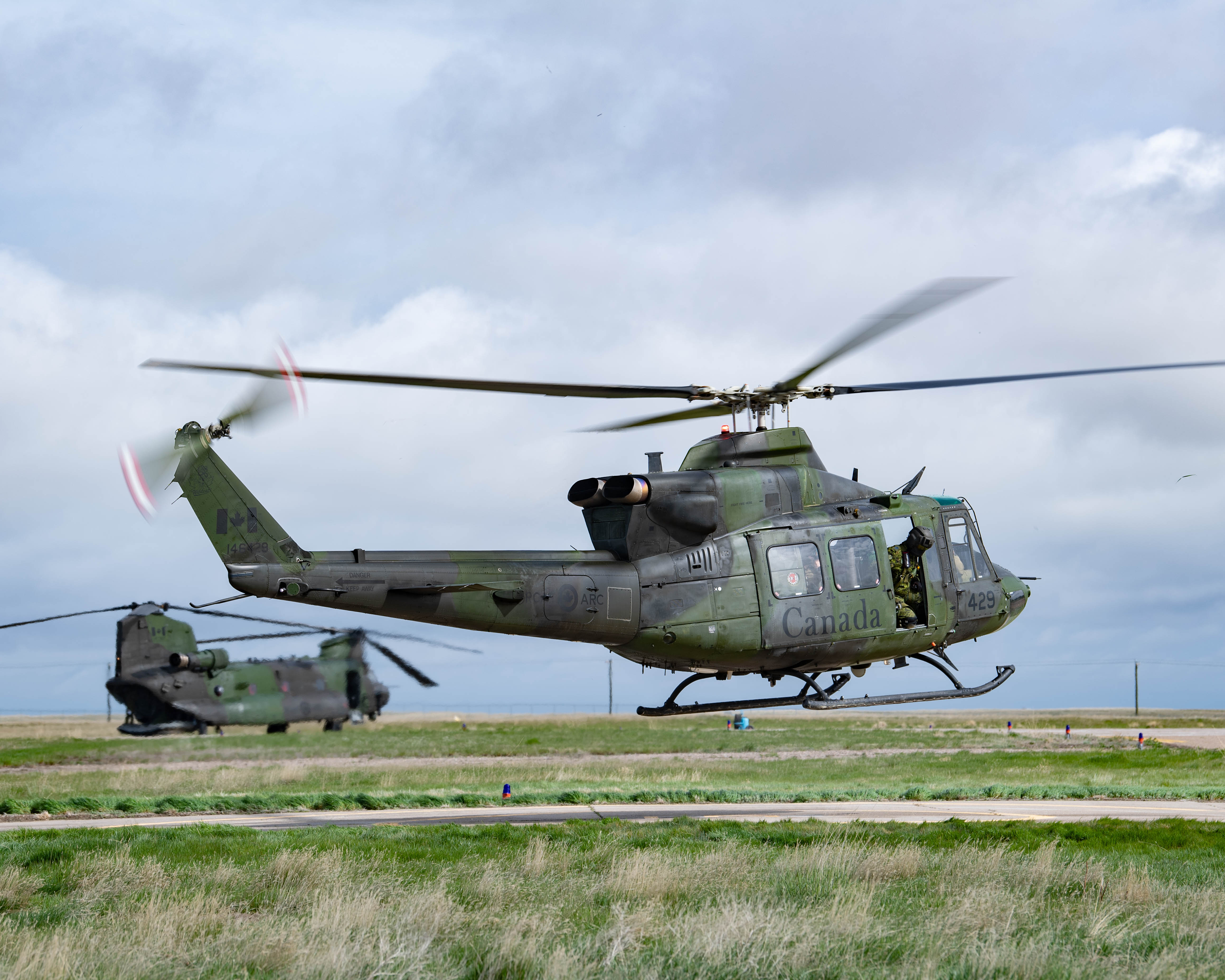 Two military helicopters taking off